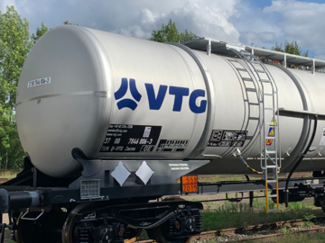 White tank wagon under a cloudy sky