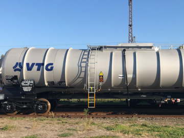 White tank wagon under a blue sky